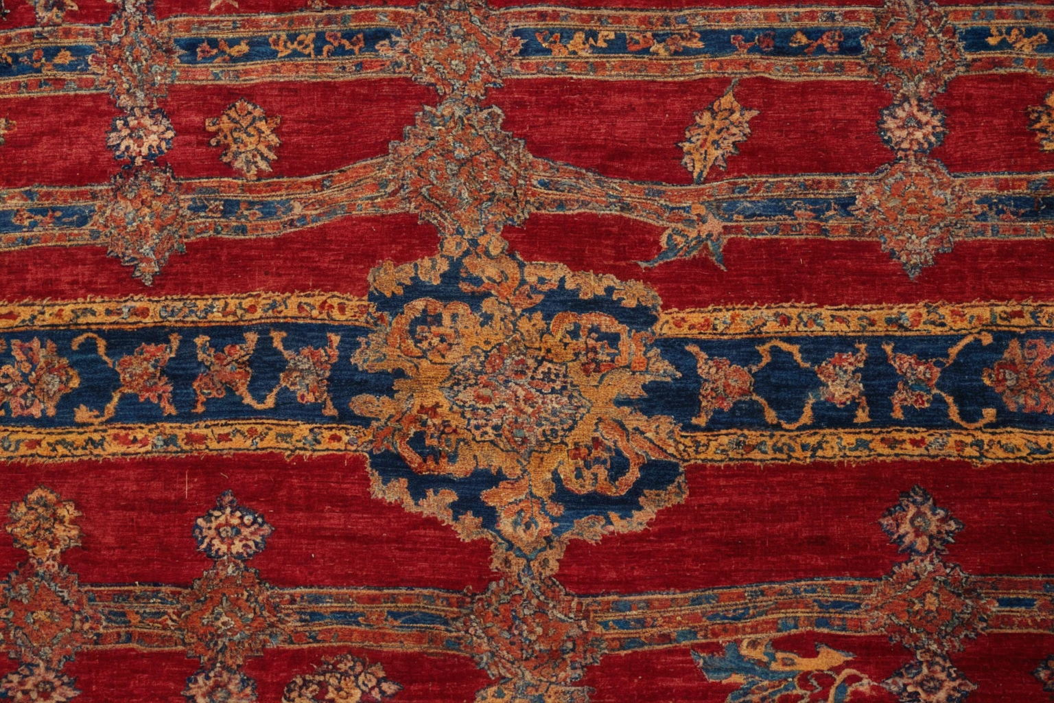 Macro detail of hand-knotted wool pile on an Ottoman Cairene style carpet, palmette drawing in madder red, saffron yellow and indigo